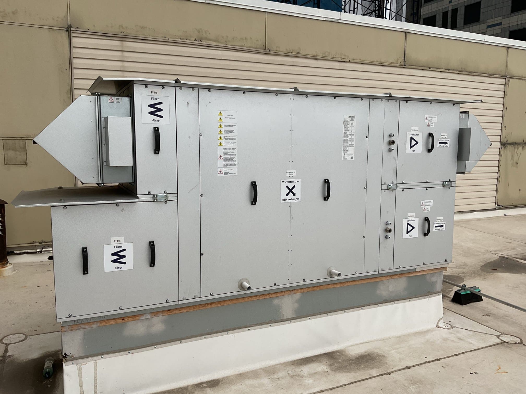 Packaged air handler set on a curb on a NYC commercial rooftop